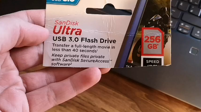 A video of Erik Uden zooming into the description of a 256 GB SanDisk USB 3.0 Stick claiming to be capable of transferring a movie very quickly. The video then pans to Erik Uden's laptop showing a file transfer of said laptop being at around one megabyte per second. He is very enraged by that fact.