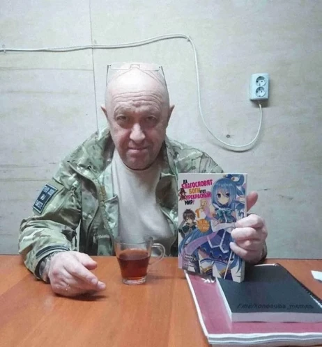 An image of Yevgeny Prigozhin, leader of the Wagner Group mercenaries, holding the Russian translation of a Konosuba (Manga) book in his left hand.