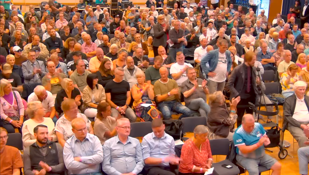 Ein Bild vom AfD Bürgerdialog in Weitaufnahme auf dem man Erik Uden inmitten von 300 Wutbürgern.