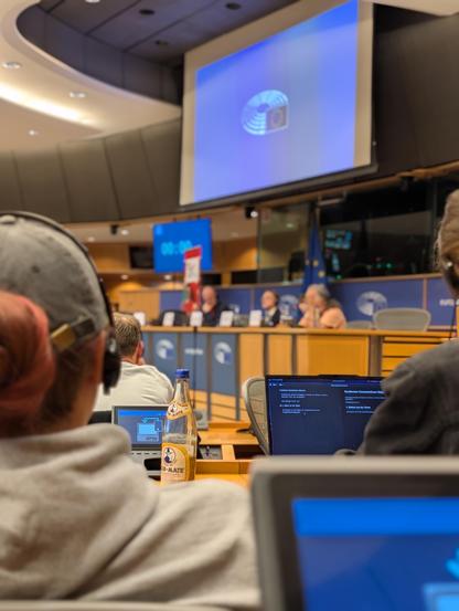 A picture of many people sitting inside of an EU conference room